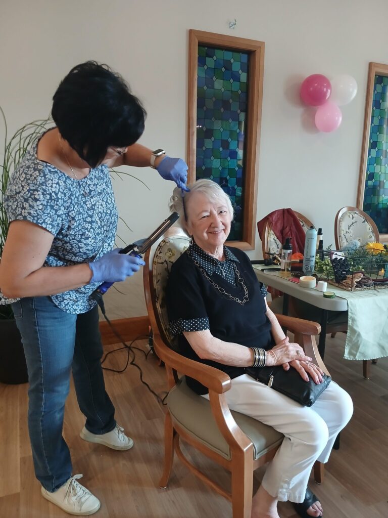 Stylist working on a residents' hair